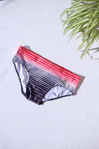 A single pair of SOLAR brand vintage 80s men's swim briefs featuring a red-to-black gradient horizontal stripe pattern.