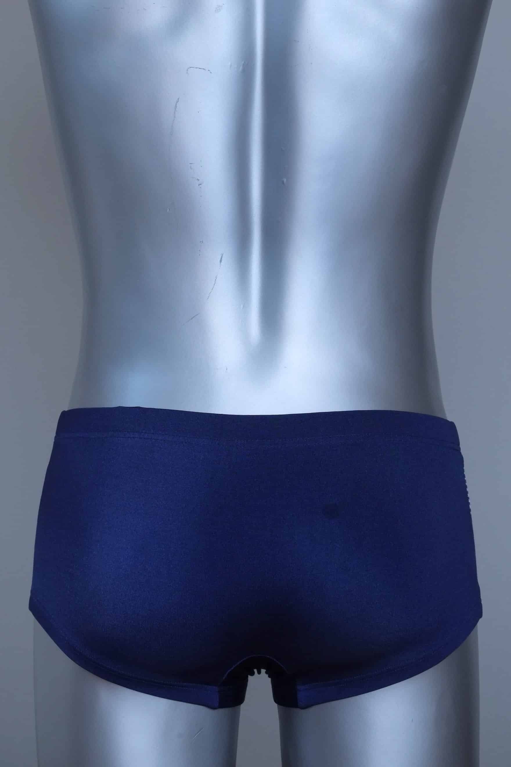 Back view of a Vintage navy and yellow striped men's swim briefs on a silver mannequin against a gray background