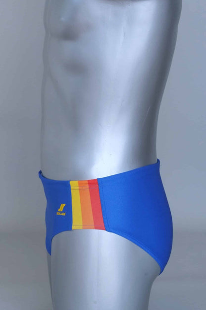 Side view of vintage blue swim briefs with colorful side band on a mannequin against a gray background