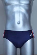 Navy swim briefs with colorful side band on a mannequin against a gray background