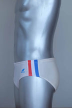 Side view of vintage white swim briefs with colorful side band on a mannequin against a gray background