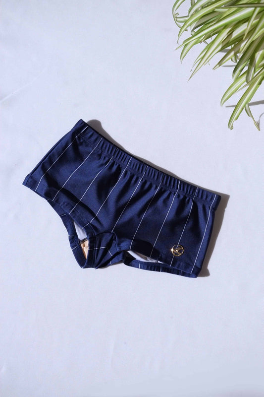 A single pair of SOLAR brand vintage 80s men's navy square-cut swim briefs with thin white vertical stripes and a gold metal logo on a white background.