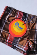 Vintage plaid swim briefs with a visible brand tag Solar sportswear on a light gray background