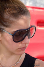 Model wearing dark blue sporteam vintage frames
