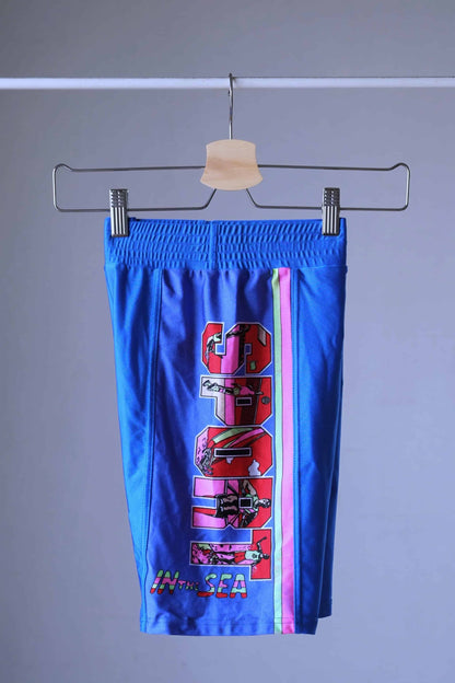 Side view of the blue vintage Sprider swim trunks hanging on a hanger.