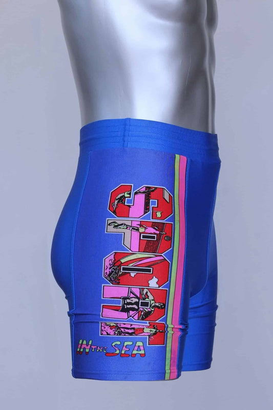Side view of the blue vintage Sprider swim trunks on a mannequin, highlighting the colorful print and "SPORT IN THE SEA" text.