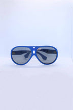 Front view of vintage 1970s SKILOOK matte cobalt blue shield-style alpine sunglasses with a silver metallic nose bridge accent and gray lenses against a white backdrop.