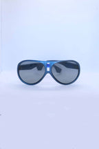 Front view of vintage 1970s SKILOOK metallic dark blue shield-style alpine sunglasses featuring a silver nose bridge insert and gray lenses against a white backdrop.