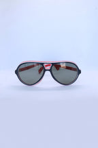 Front view of vintage 1970s SKILOOK tricolor drop aviator sunglasses with a navy blue frame, red inner rim, white pinstripe accents, and dark grey lenses.