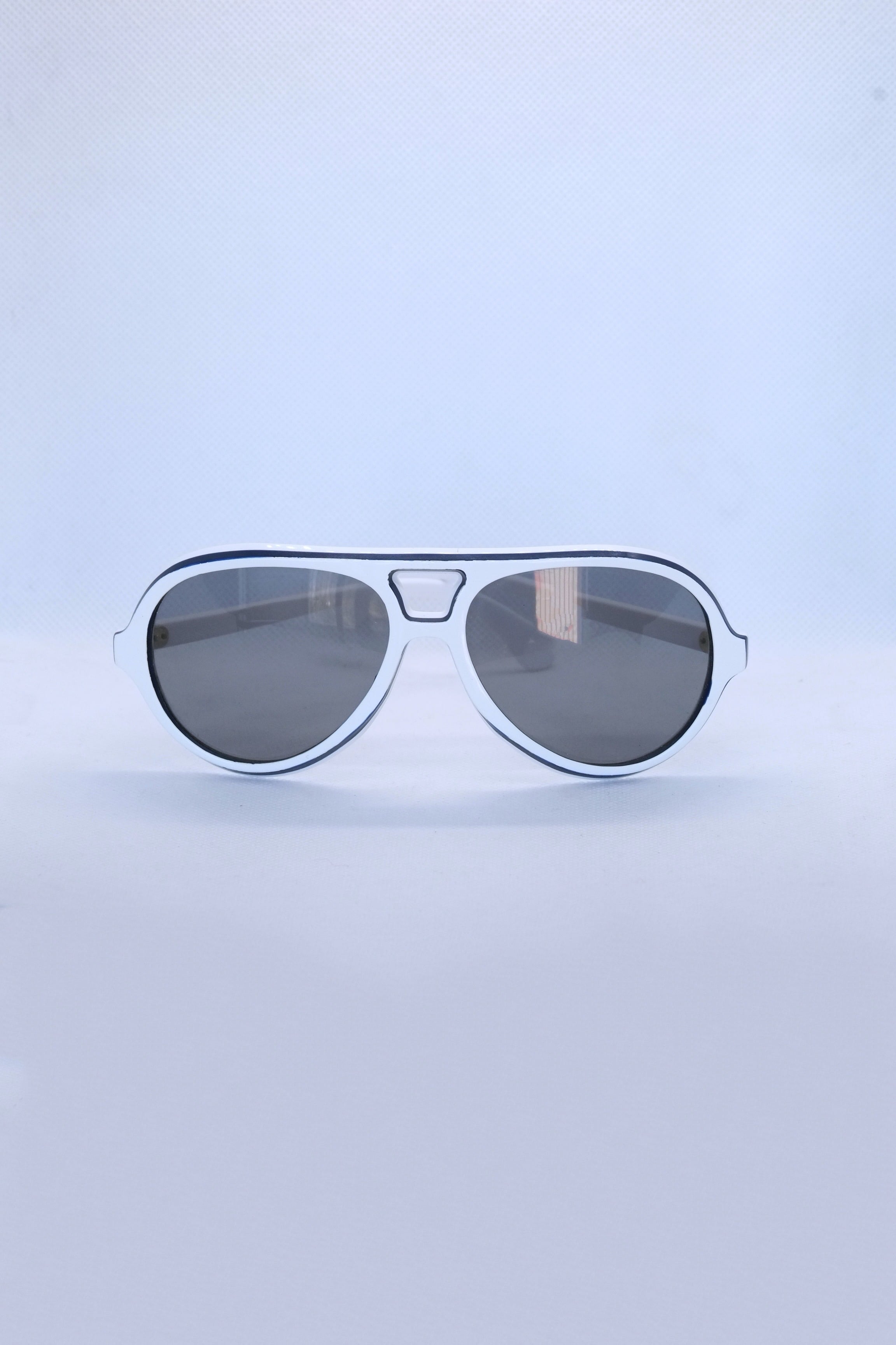 Front view of vintage 1970s SKILOOK tricolor drop aviator sunglasses featuring a crisp white acetate frame with navy blue outer trim and dark gray lenses.