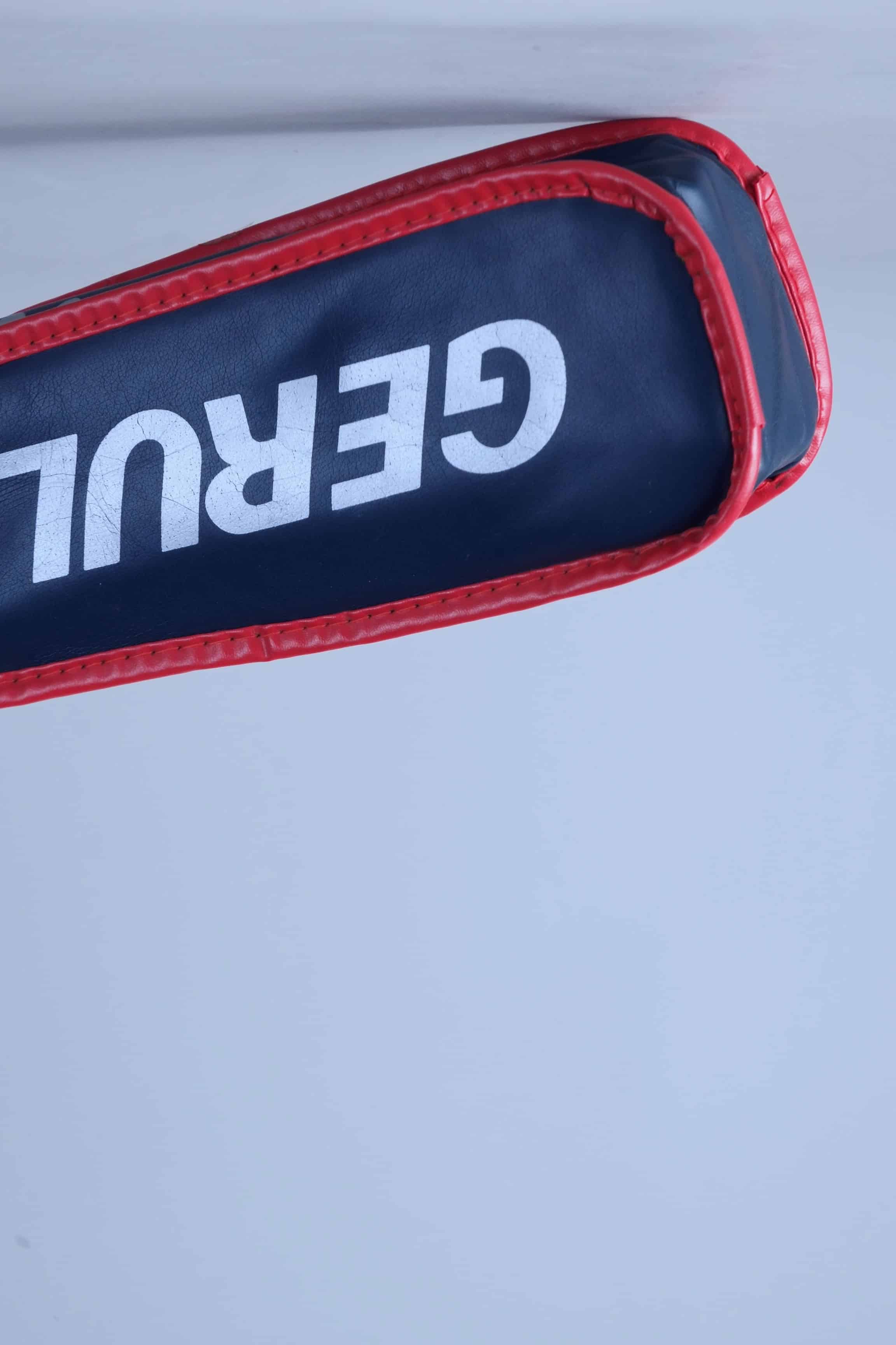 Base angle view of the vintage tennis cover where the racquet handle exits the zippered vinyl case.