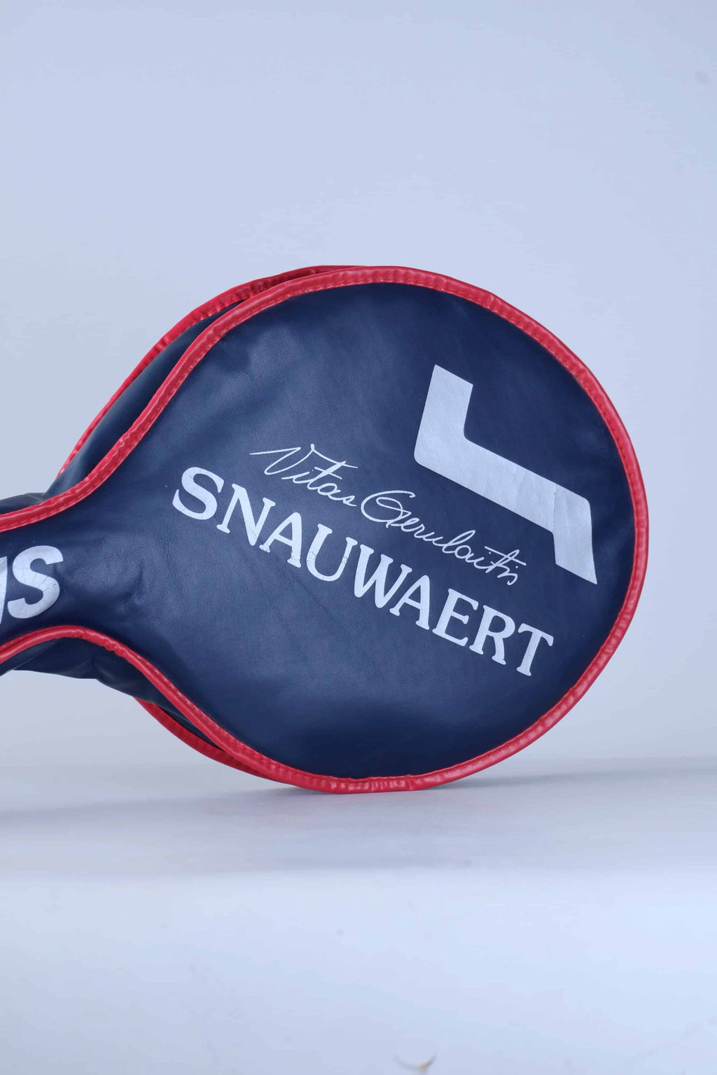 Angled view of the vintage Snauwaert vinyl racquet cover, showcasing the blue printed Vitas Gerulaitis signature text.