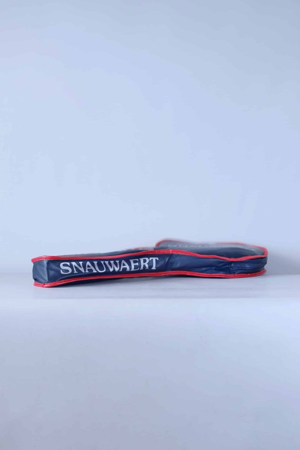 Side profile view of the archival Snauwaert tennis racquet cover, highlighting its slim zippered construction.