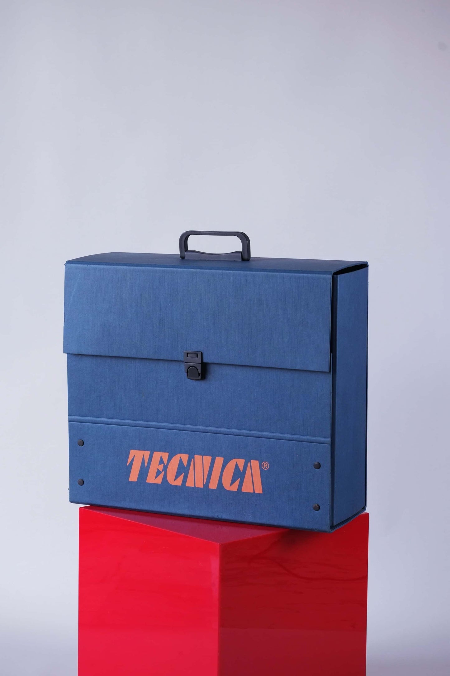 Angled front view of a vintage 1990s Tecnica promotional dealer briefcase in blue with orange logo.