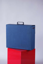 Rear view of the blue Tecnica dealer promo case showing solid back and black handle.