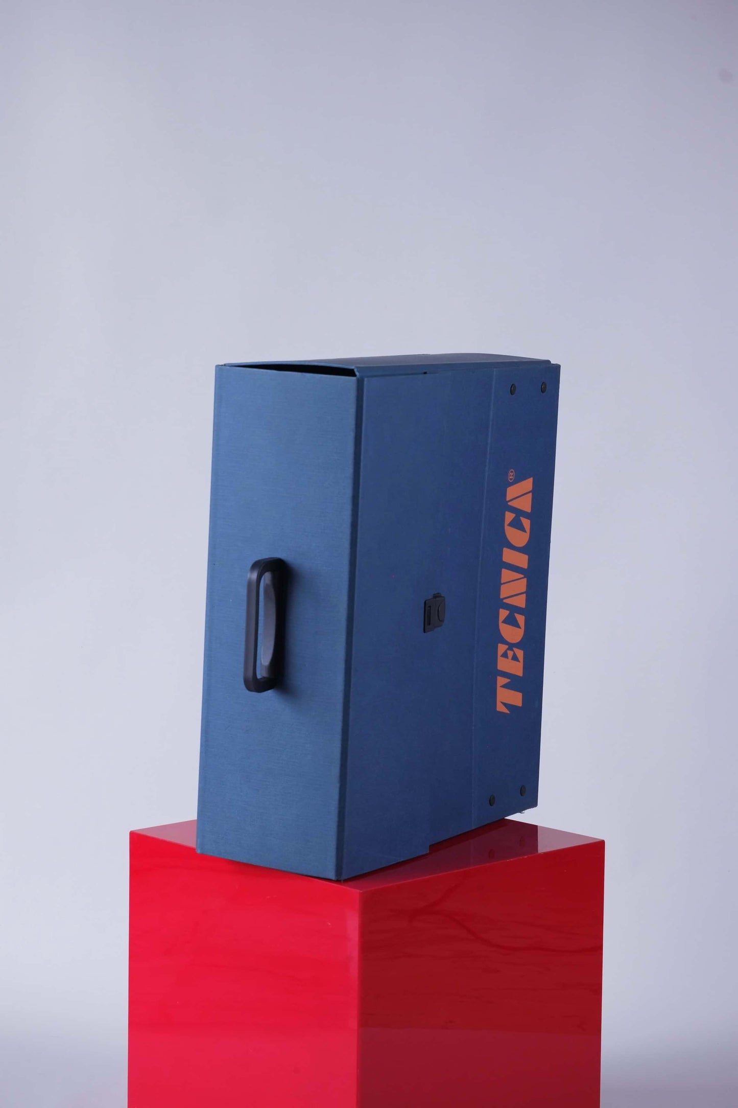 Top-down view of the Tecnica promotional case showing black carry handle and clean lines.