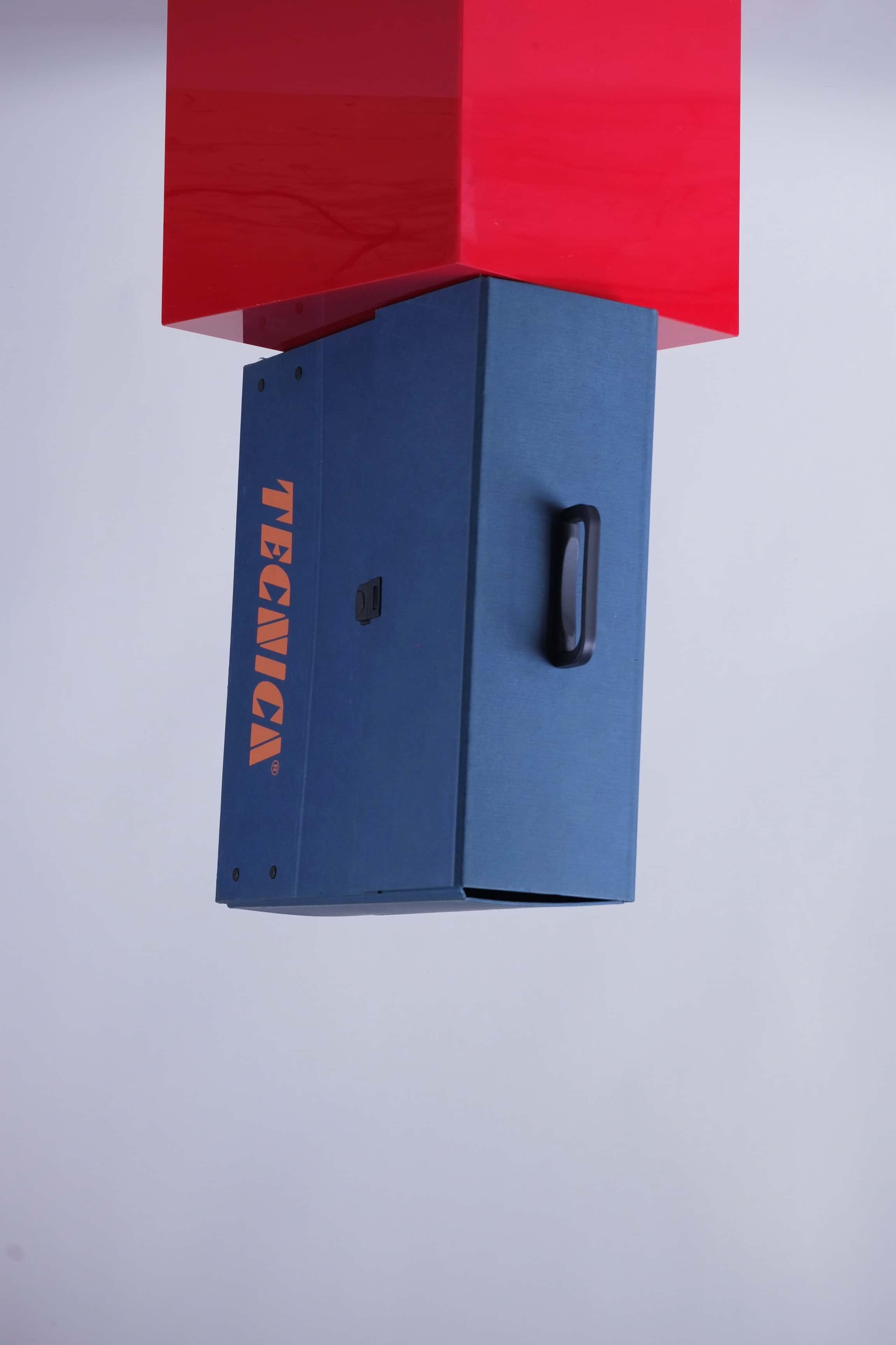 Top-down view of the Tecnica promotional case showing black carry handle and clean lines.