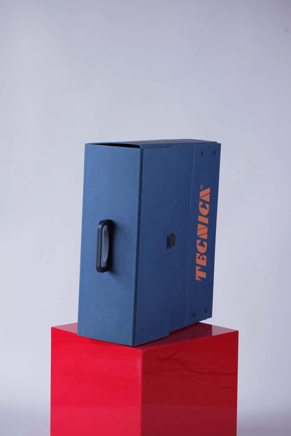 Top-down view of the Tecnica promotional case showing black carry handle and clean lines.