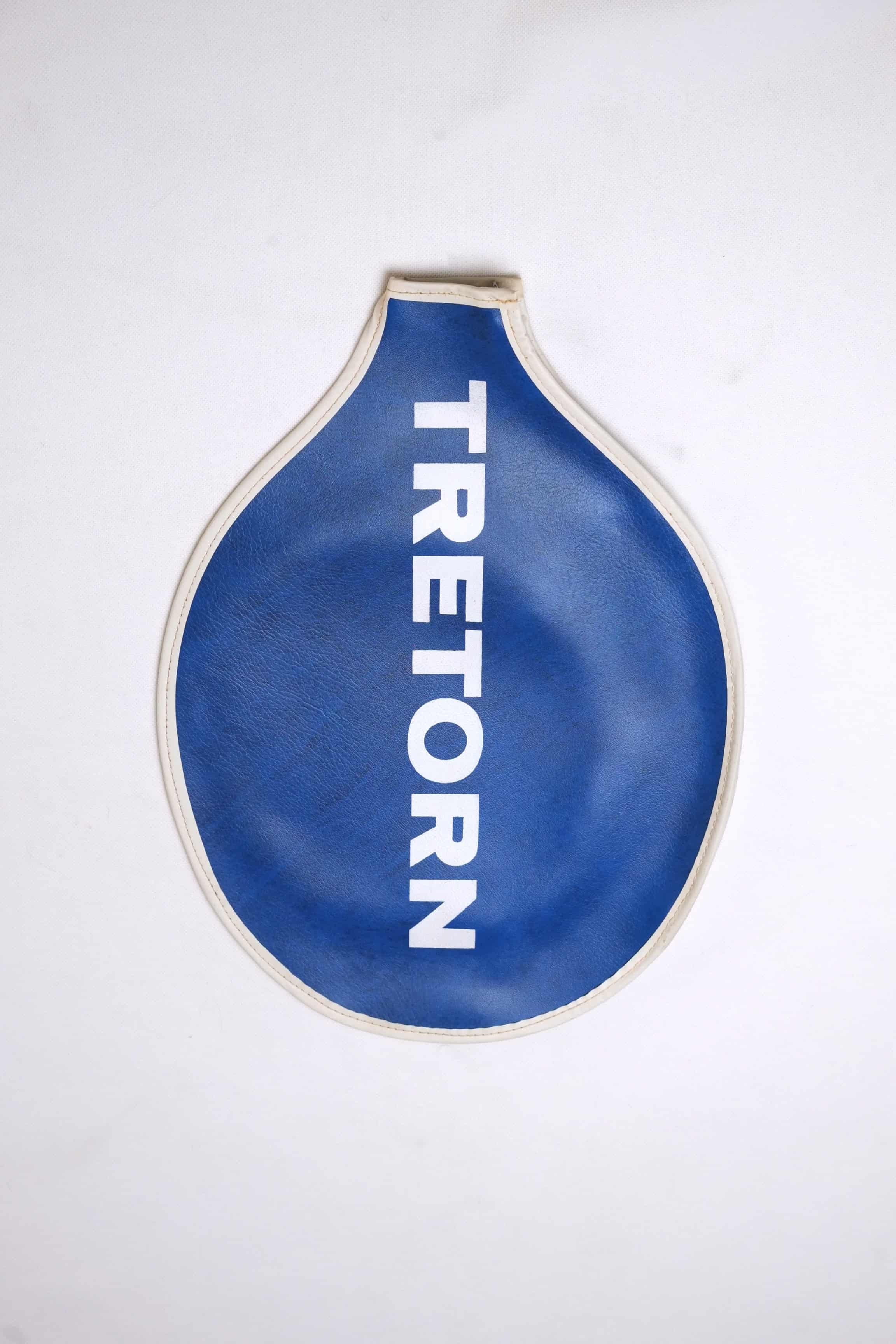 Vintage royal blue grained vinyl Tretorn tennis racket head cover with vertical white block lettering and cream-colored edge piping.