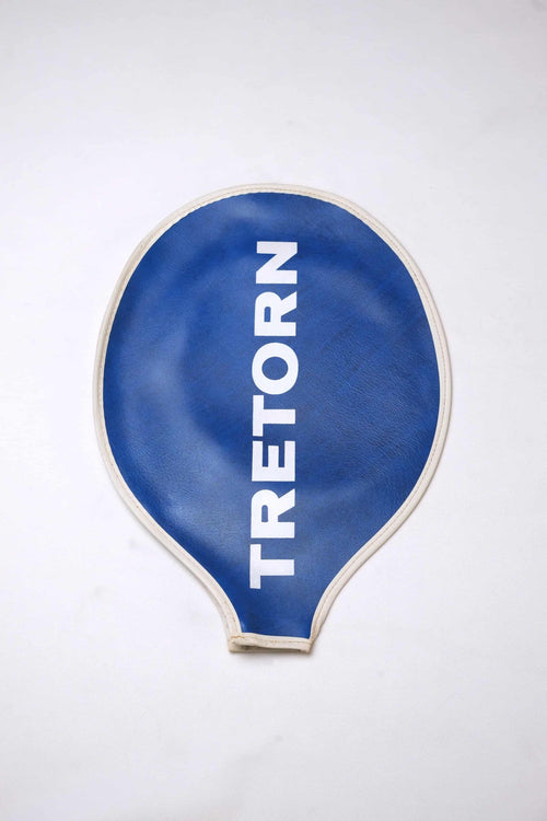 Vintage royal blue grained vinyl Tretorn tennis racket head cover with vertical white block lettering and cream-colored edge piping.