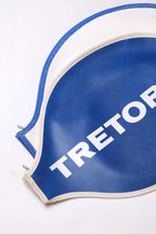 Close-up cropped view of two fanned-out vintage Tretorn vinyl racket covers in white and royal blue, emphasizing the stitched border detail.
