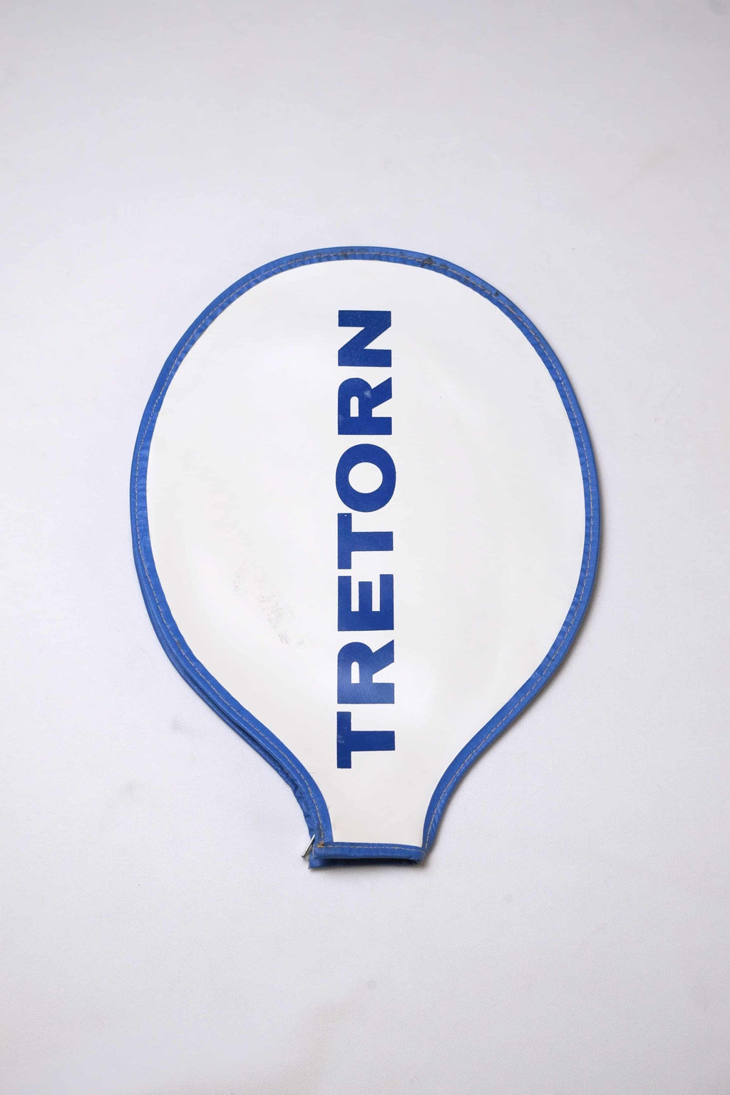 Vintage white grained vinyl Tretorn tennis racket head cover with vertical blue block lettering and blue-colored edge piping.