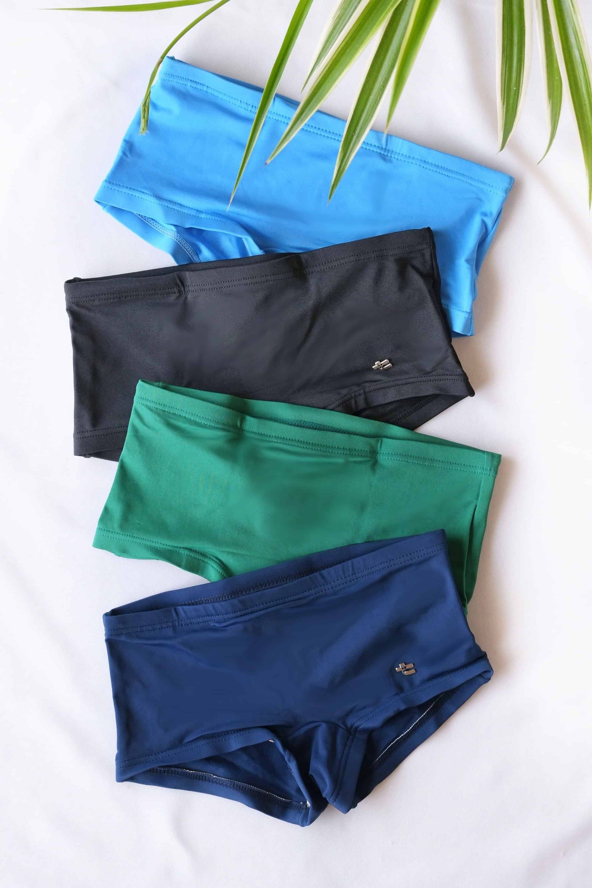 Blue, black, green, and navy Tropic vintage 70s briefs on white background