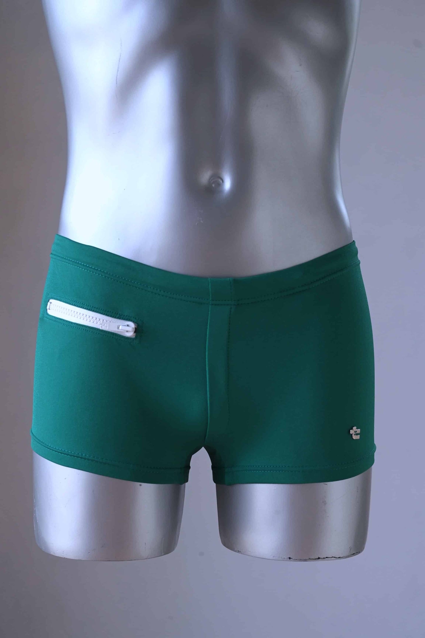 Green Vintage 70's Swim Briefs with Pocket laid on mannequin