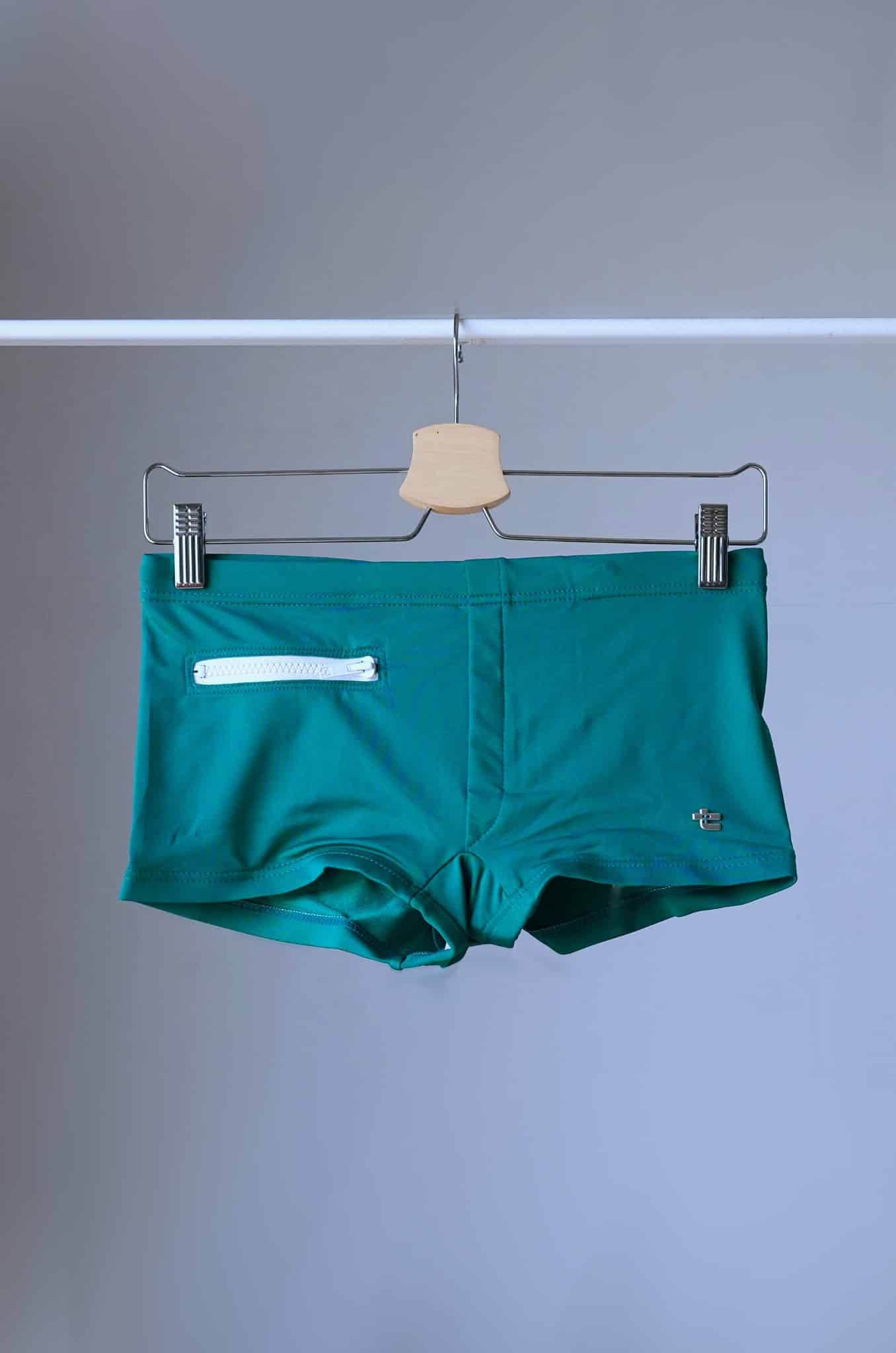 Green Vintage 70's Swim Briefs with Pocket laid on hanger