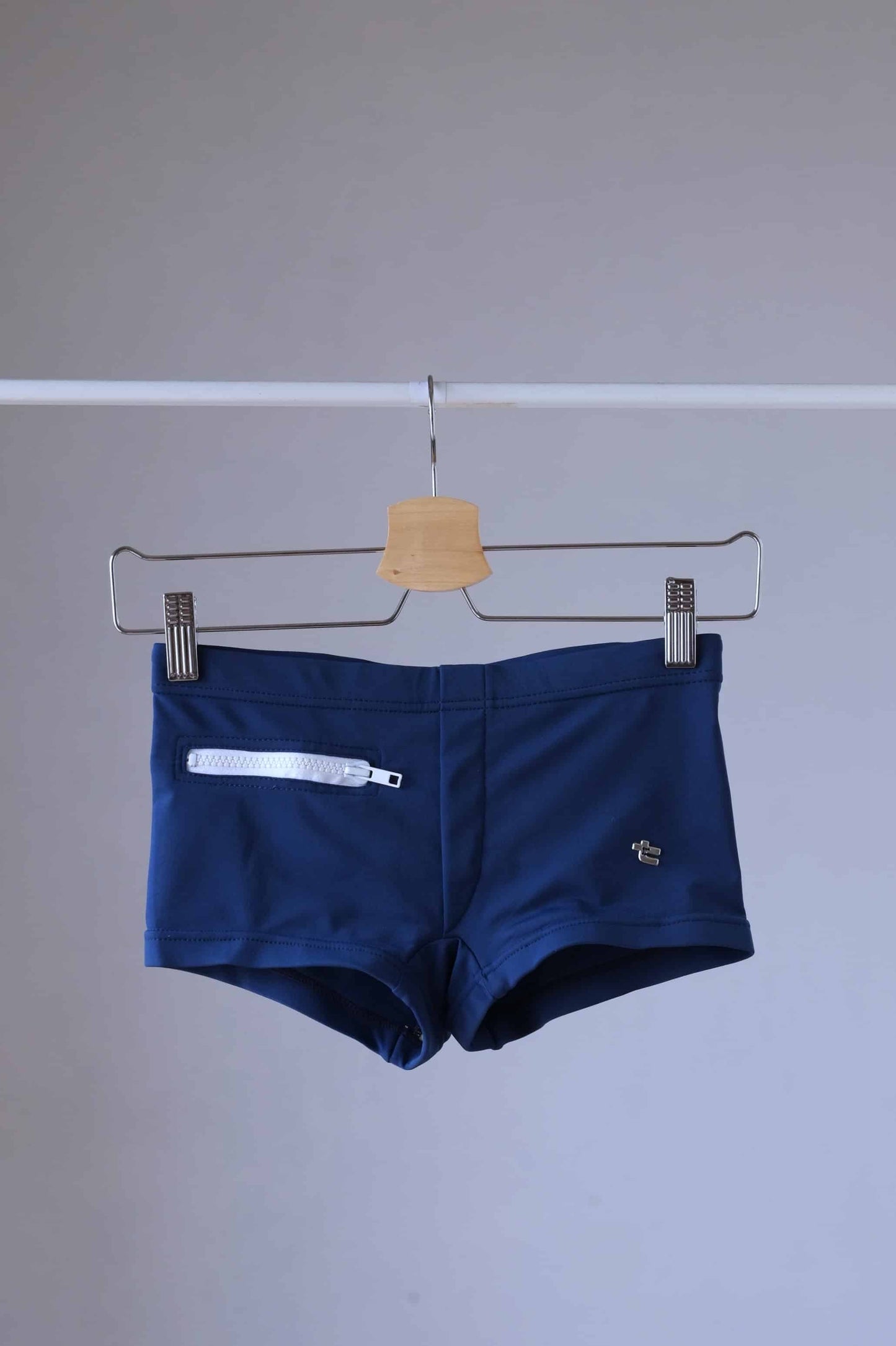 Navy Vintage 70's Swim Briefs with Pocket laid on hanger