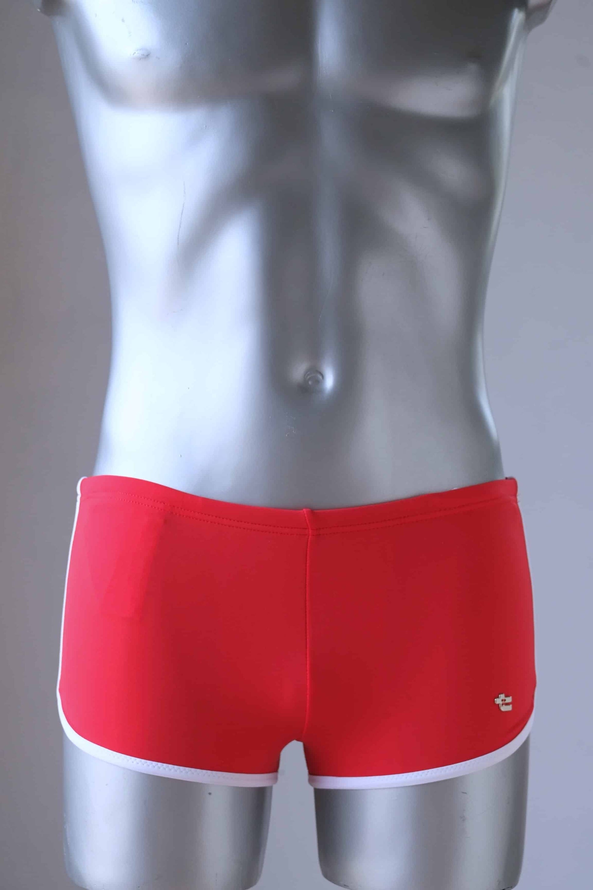 Vintage red swimming briefs on mannequin