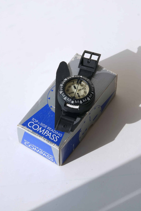 Front view of a UWATEC Vintage Oil Filled Submersible Compass, displayed on its original blue and grey box.