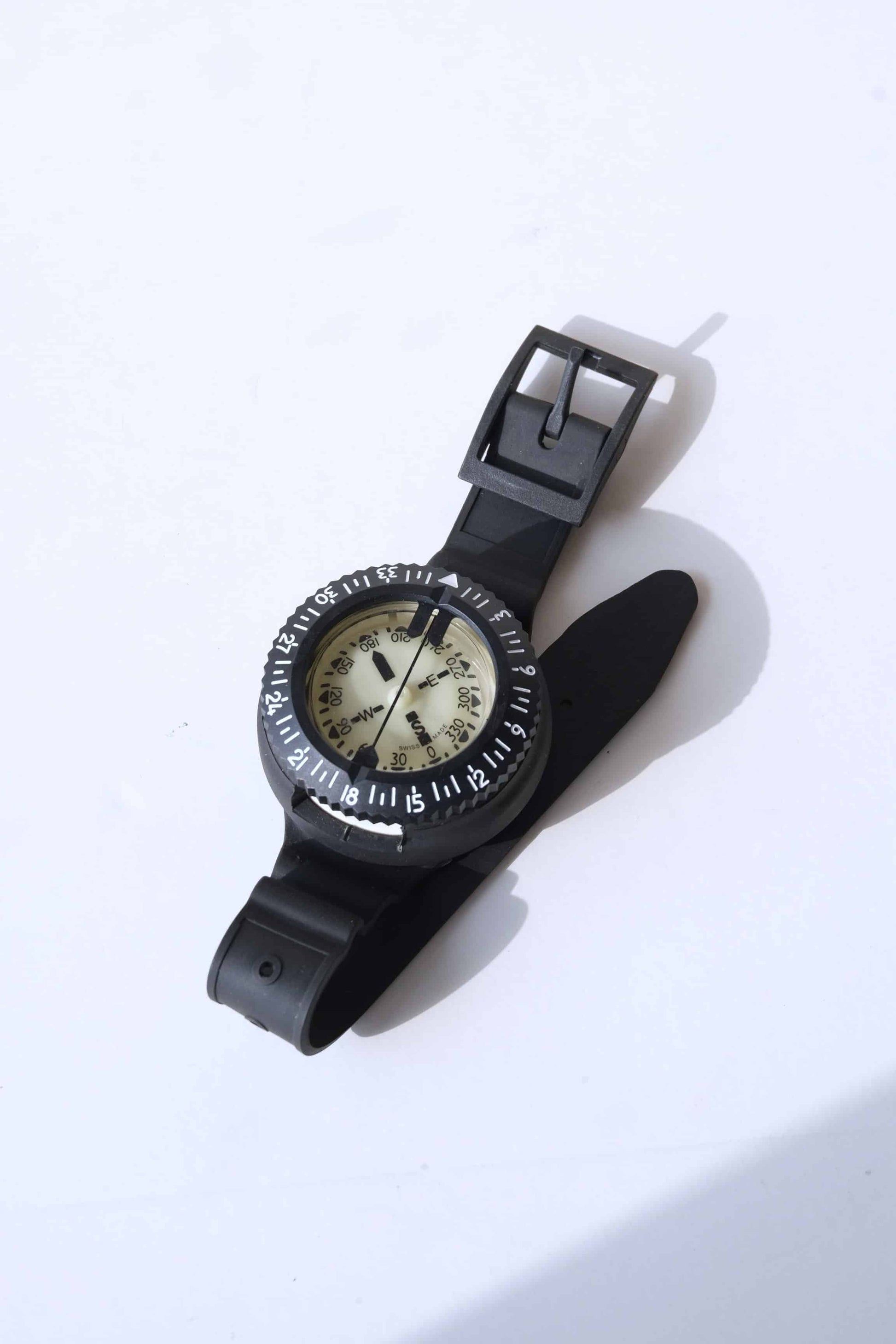 Front view of a UWATEC Vintage Oil Filled Submersible Compass displayed with its strap folded, on a white background.