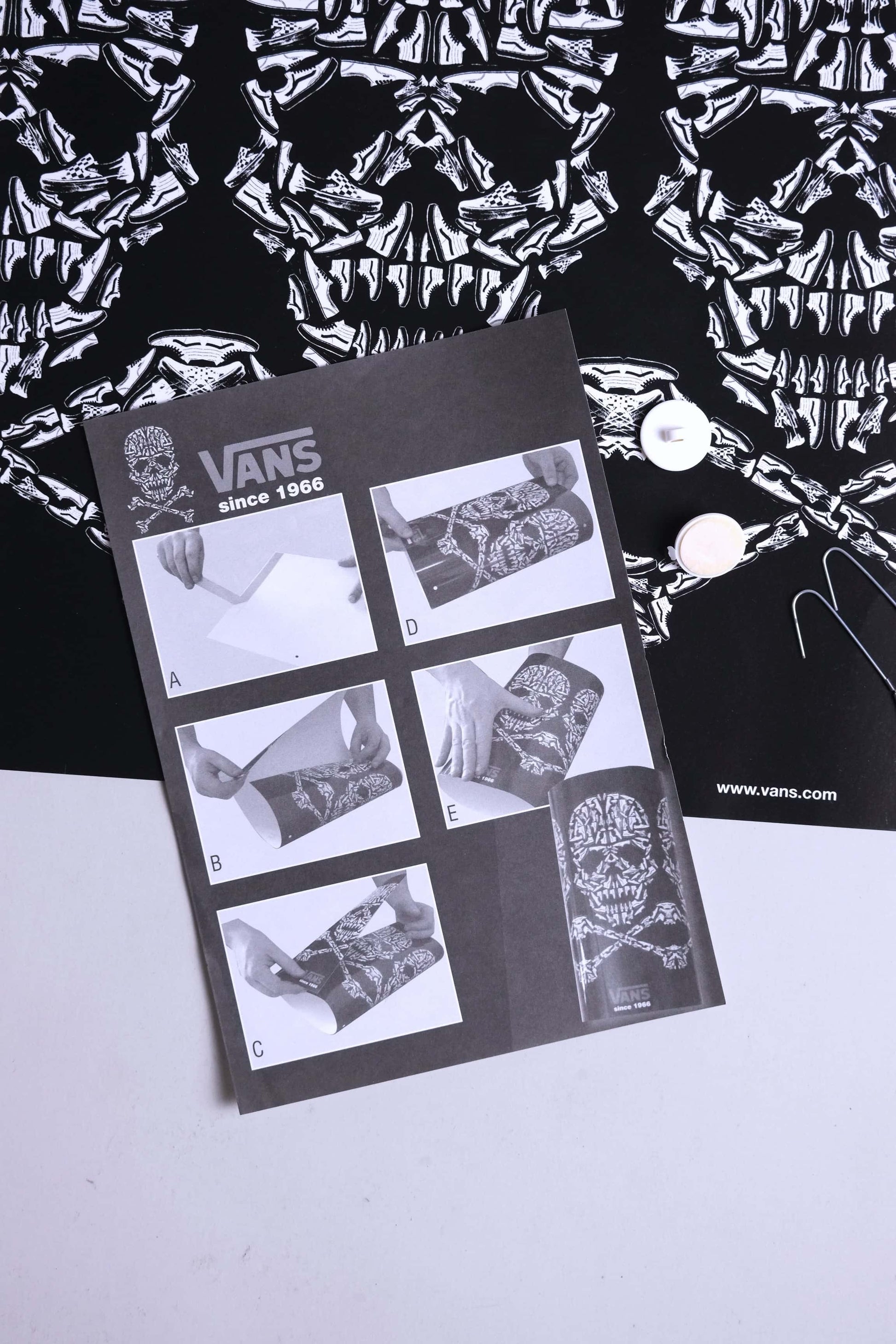 Detailed view of VANS 2008 skull mobile instruction manual and printed skull artwork.