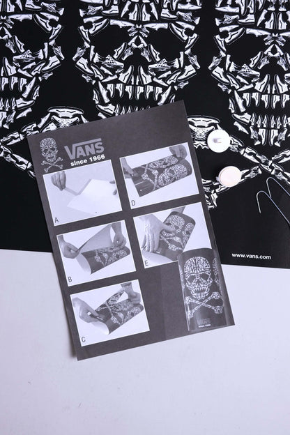 Detailed view of VANS 2008 skull mobile instruction manual and printed skull artwork.