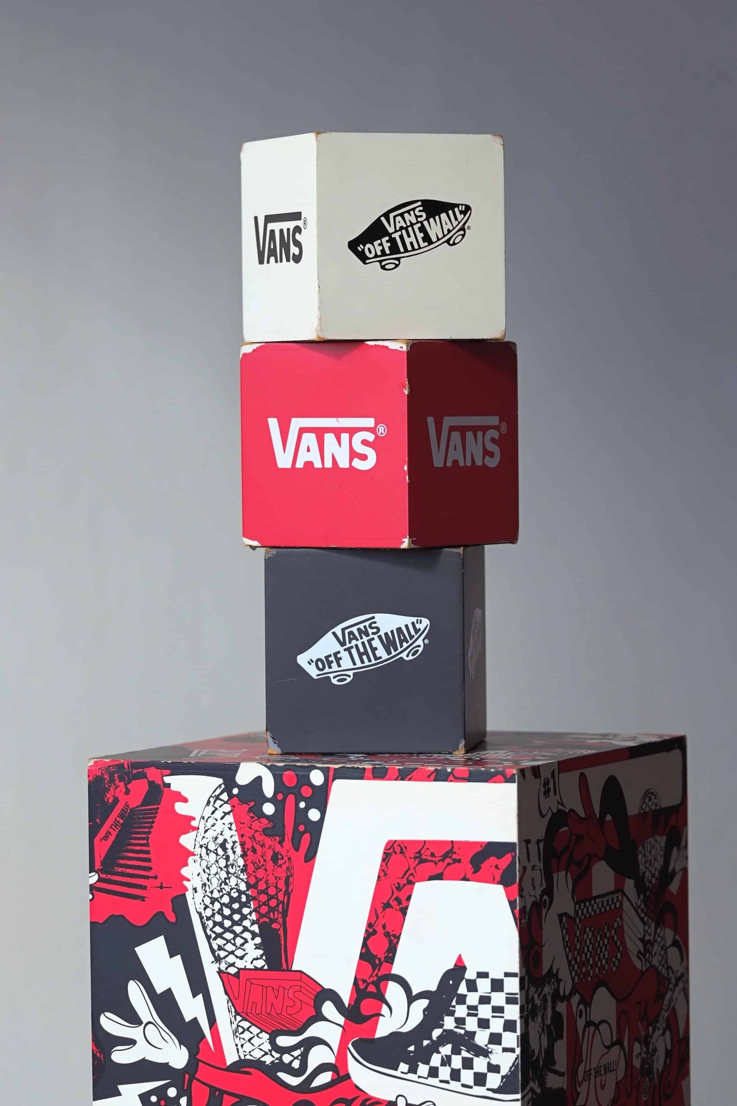 Close-up of the smallest VANS display cubes showing ‘Off The Wall’ logos and nesting fit inside the largest cube.