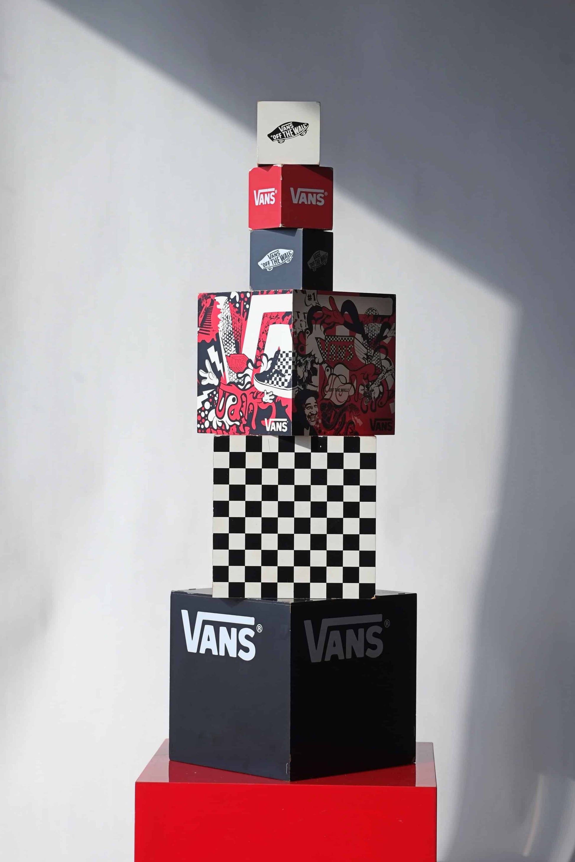 Front view of full VANS vintage dealer display set featuring 6 stacked cubes with red, black, and white branding, checkerboard, and graphic art.