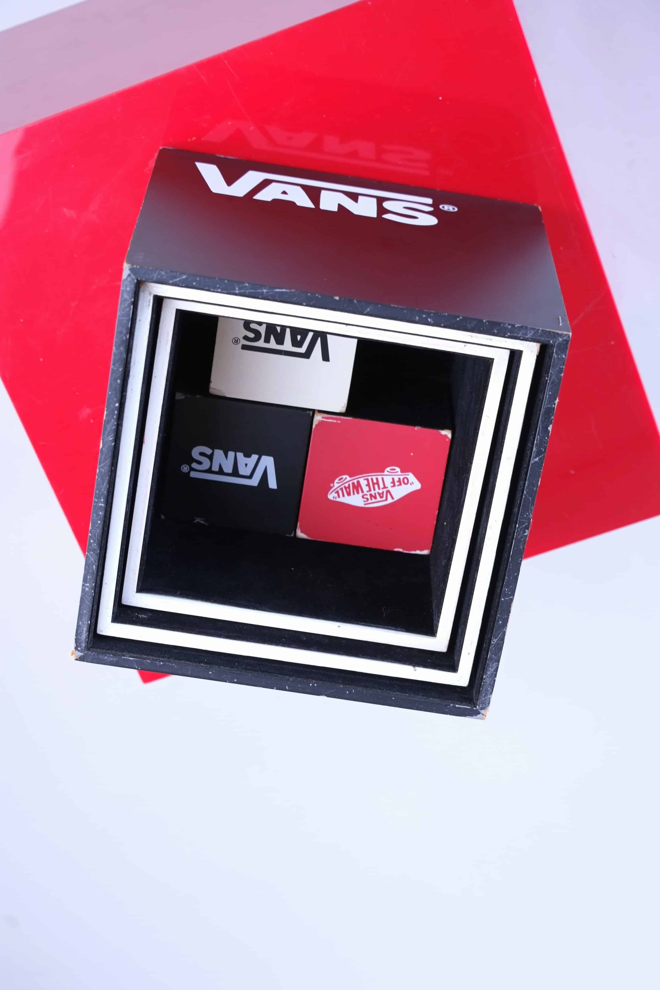 Top-down photo of the VANS display cubes neatly nested inside the largest black cube, showing efficient storage design.