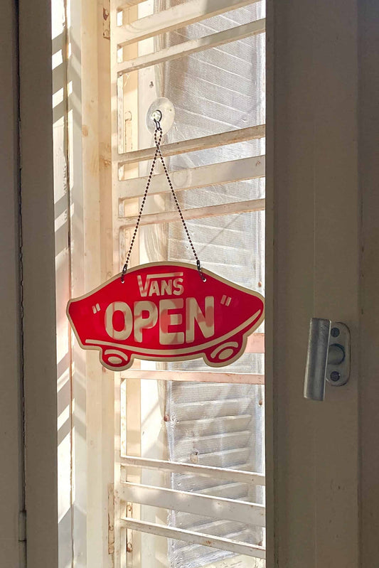 VANS Open/Closed Door Sign hung on a window
