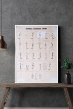 1970s dumbbell workout chart in a white frame on a gray concrete wall – minimalist home gym décor mockup.