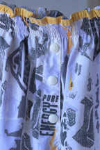 Close view of the front buttons of vintage printed volkl tennis shorts on hanger