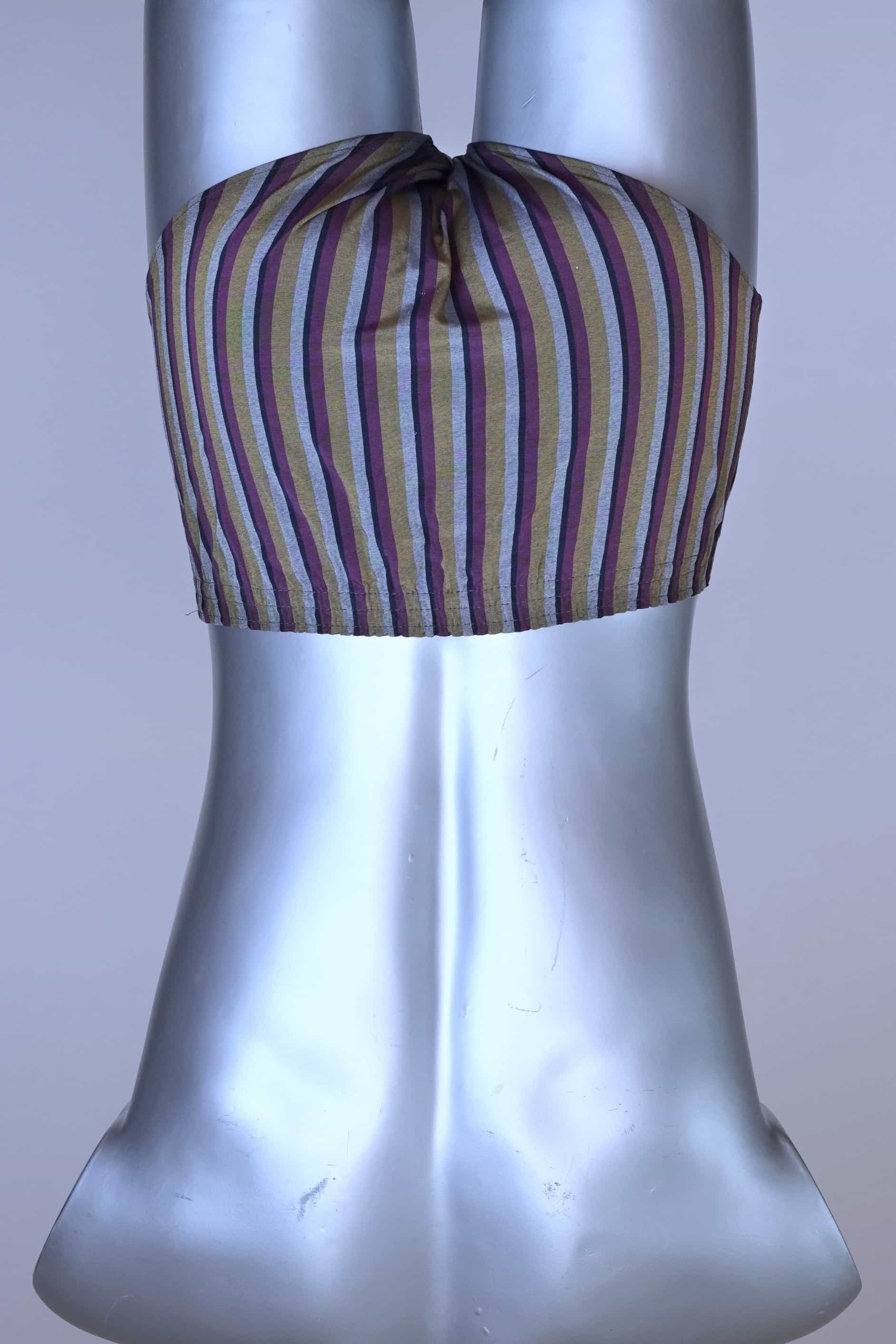 Back view of a vintage late 1950s to early 1960s men's swim brief on a silver mannequin. The brief features vertical stripes in muted brown, grey, and maroon tones, with a small front flap pocket.