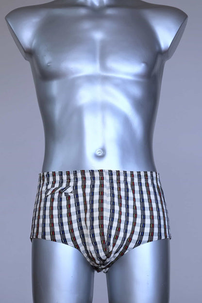 Front view of a vintage late 1950s to early 1960s men's swim brief on a silver mannequin. The brief features a plaid pattern in white, blue, and red, with a small front flap pocket.