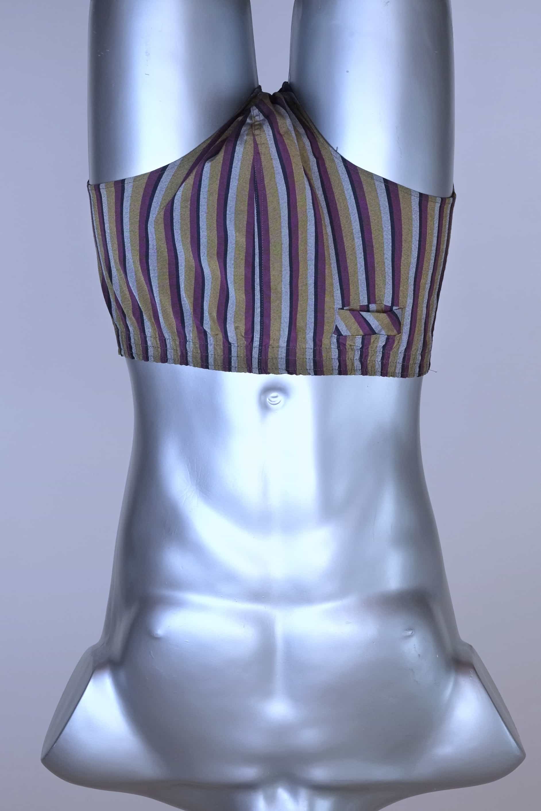 Front view of a vintage late 1950s to early 1960s men's swim brief on a silver mannequin. The brief features vertical stripes in muted brown, grey, and maroon tones, with a small front flap pocket.