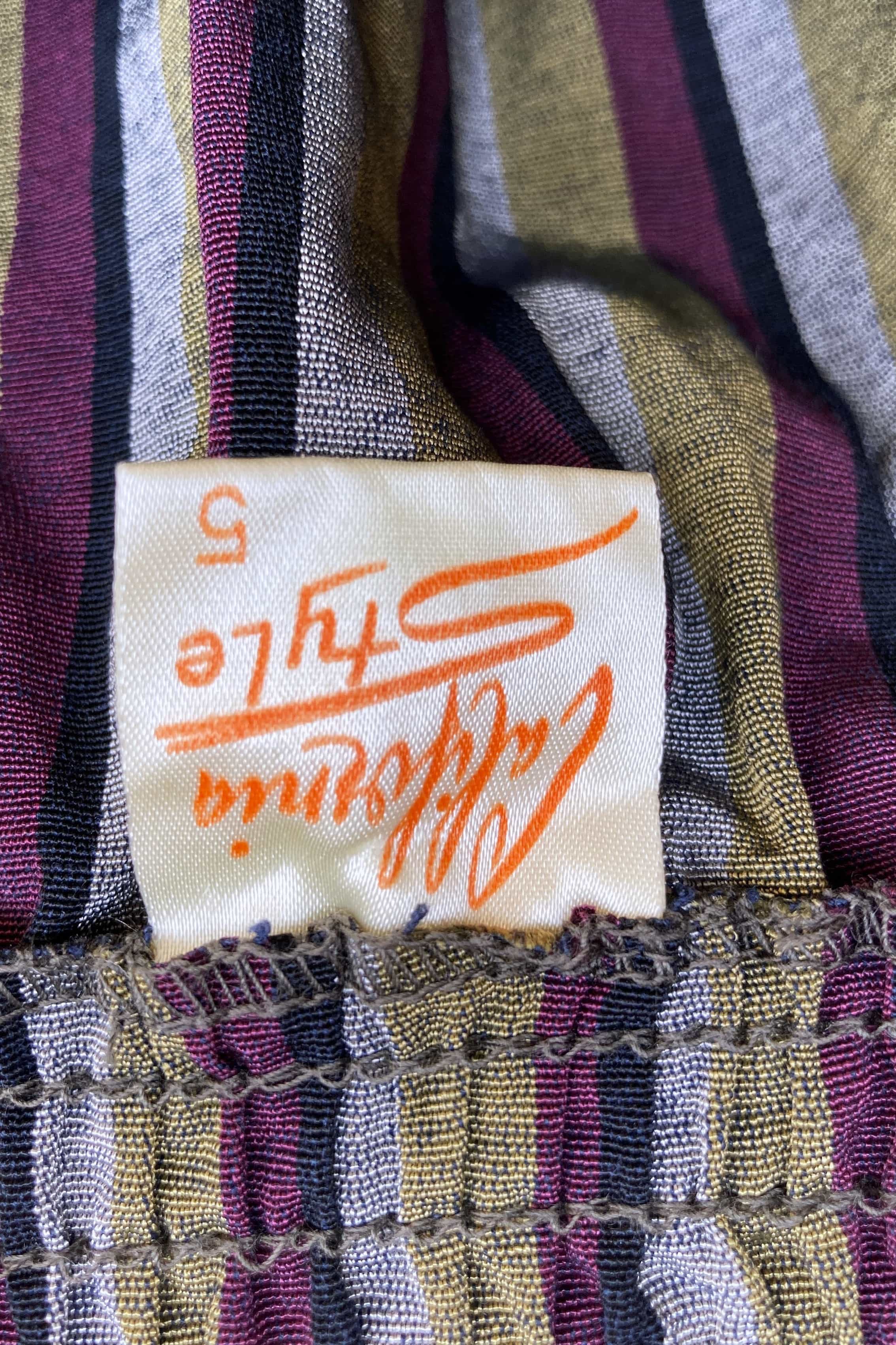 Close-up of a striped fabric with a brand label featuring the stylized text California Style.