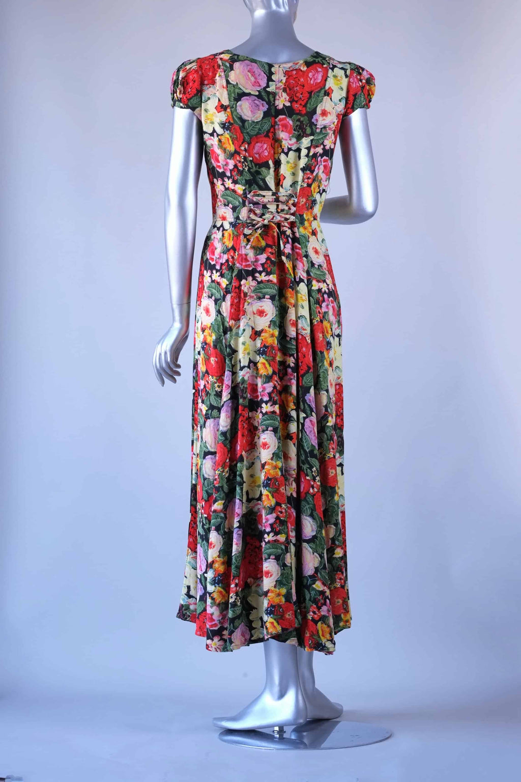 Back view of vintage 90s floral maxi dress on mannequin showing corset lace-up waist detail