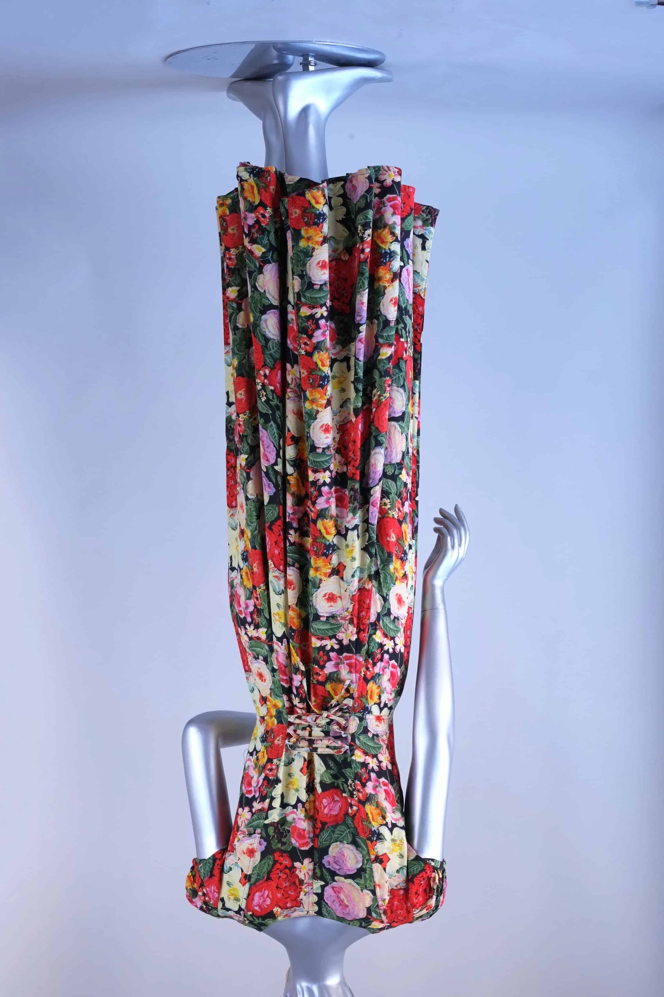 Back view of vintage 90s floral maxi dress on mannequin showing corset lace-up waist detail