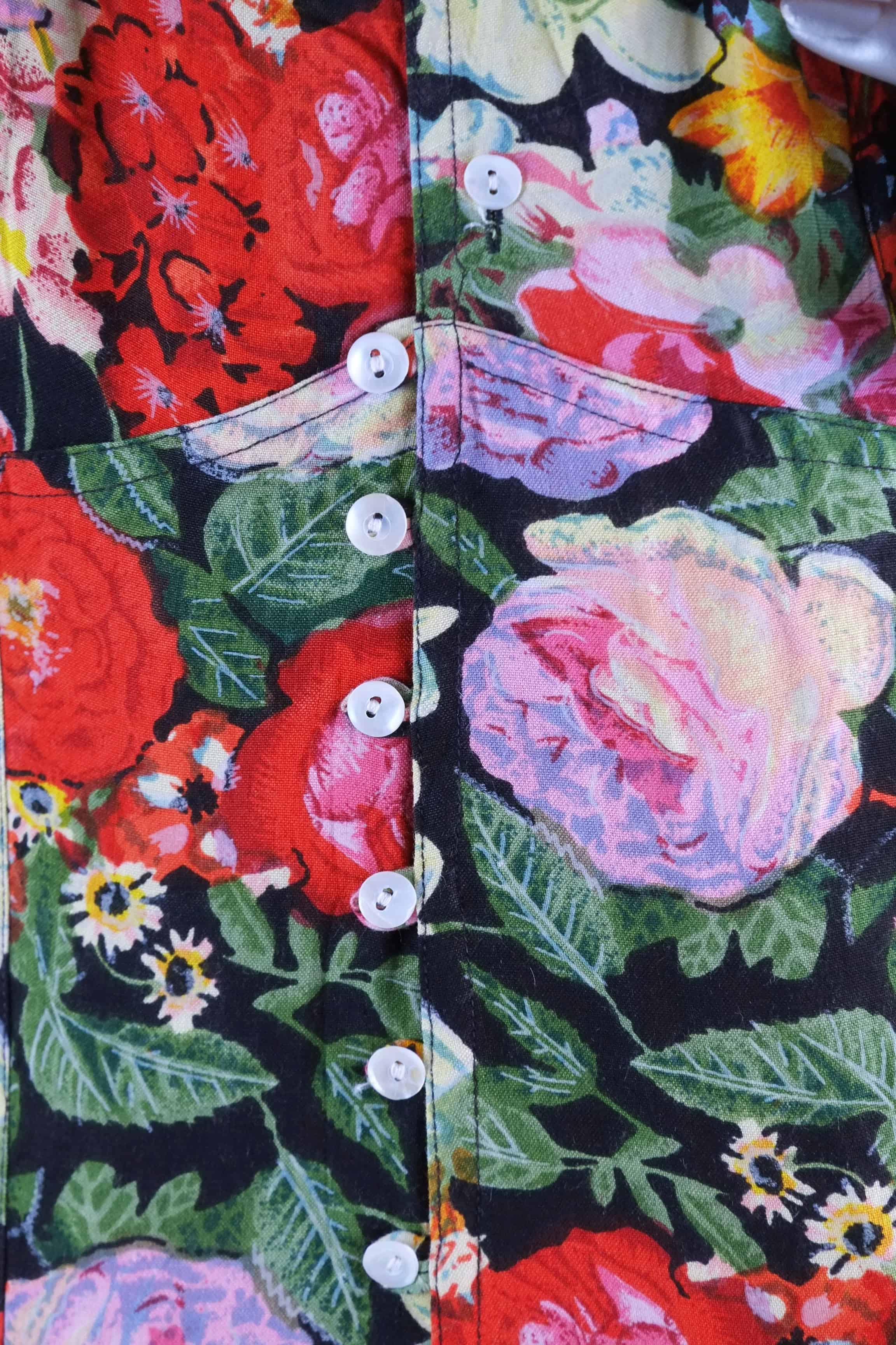 Close-up of mother-of-pearl buttons on vintage 90s floral print maxi dress bodice