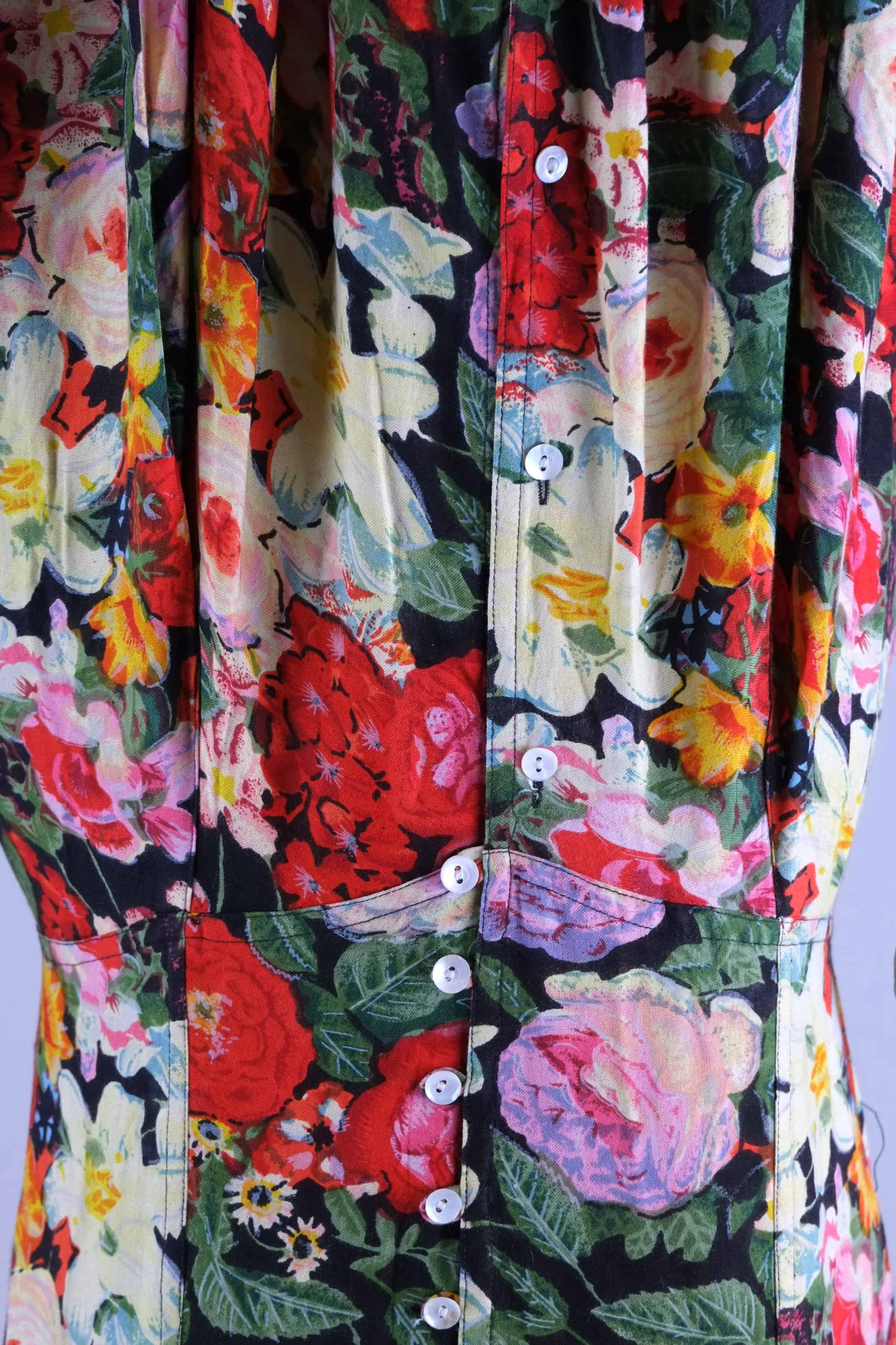 Close-up of button placket and seaming at waist on vintage 90s floral maxi dress
