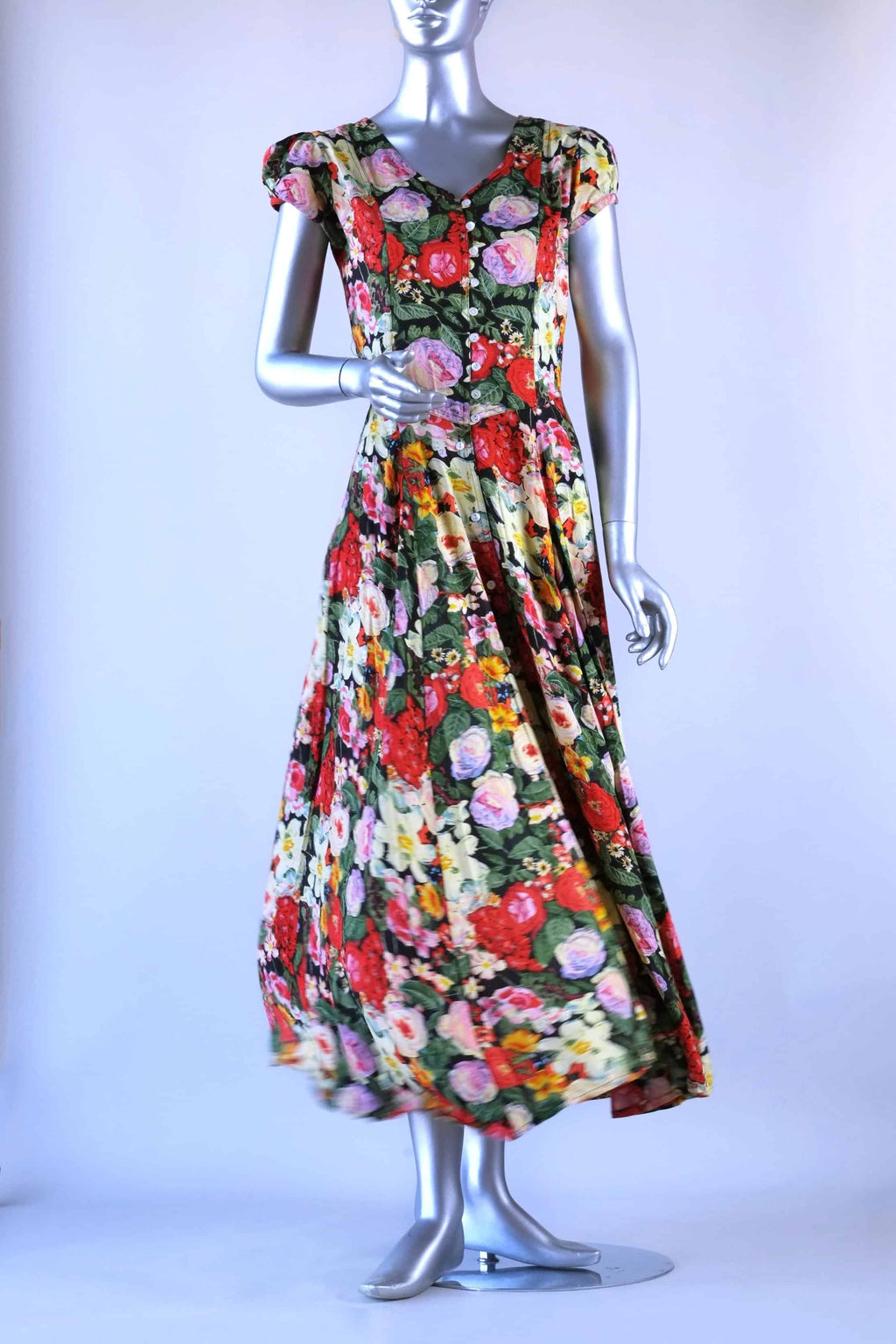 Front view of vintage 90s floral maxi dress on mannequin showing cap sleeves and flowing skirt